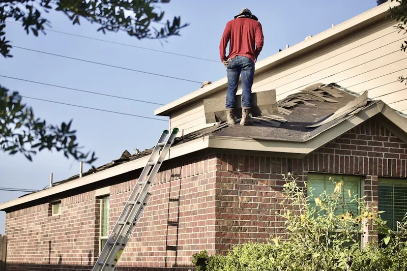 Professional roofer working on a residential roof in Palm Valley